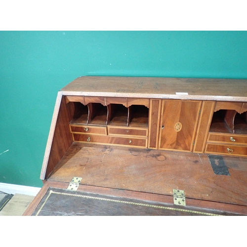 634 - A 19th Century mahogany and crossbanded Bureau, the fall down enclosing drawer and pigeon hole inter... 