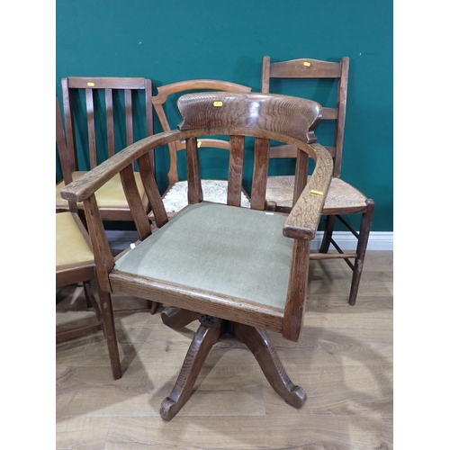 635 - A set of four Dining Chairs with drop in rexine seats, an oak framed Swivel Elbow Chair a Ladderback... 