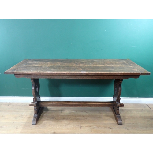 64 - An oak Trestle Table with carved shaped supports united by single central stretcher, 5ft 3