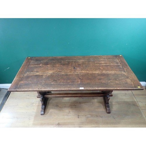 64 - An oak Trestle Table with carved shaped supports united by single central stretcher, 5ft 3
