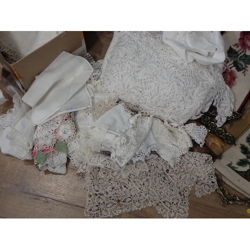 675 - A quantity of Textiles and Materials including, Lace Doilies, Table Cloths etc.