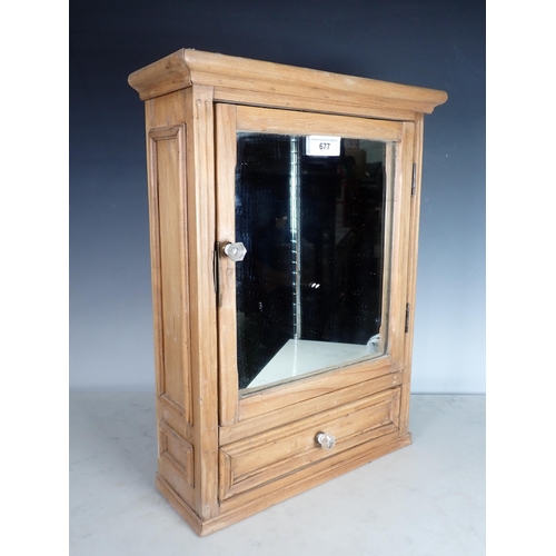 677 - A small pine mirror door Cabinet with single fitted drawer, 1ft 8