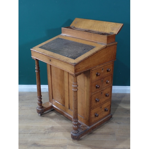 68 - An Oak four Drawer Davenport with turned supports at the front on casters 3ft 2