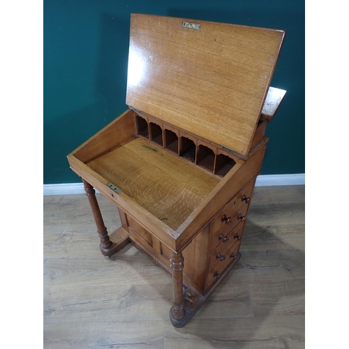 68 - An Oak four Drawer Davenport with turned supports at the front on casters 3ft 2