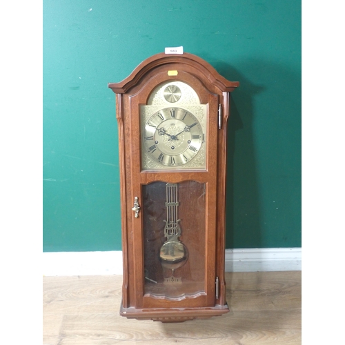 683 - A reproduction mahogany Wall Clock with arched brass dial, 2ft 11