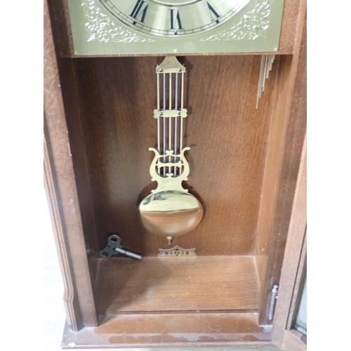 683 - A reproduction mahogany Wall Clock with arched brass dial, 2ft 11