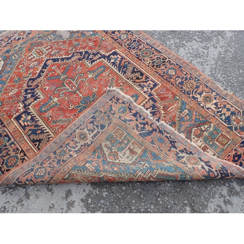 710 - A Persian Rug on red ground with blue multi-borders