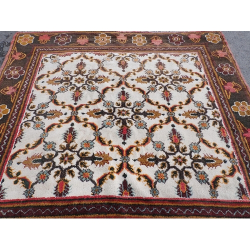 712 - A cream and green ground Rug with floral border and floral central motifs, 9ft 3in x 9ft 1in