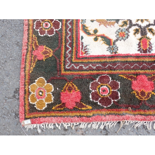 712 - A cream and green ground Rug with floral border and floral central motifs, 9ft 3in x 9ft 1in