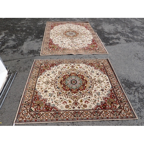 714 - Two modern Persian Rugs on beige ground with multi floral borders, central circular floral motifs, 9... 