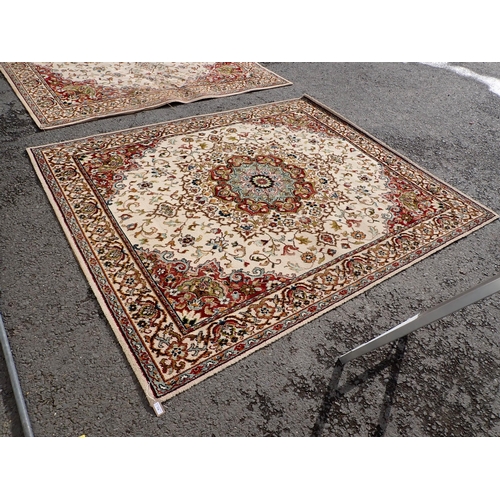 714 - Two modern Persian Rugs on beige ground with multi floral borders, central circular floral motifs, 9... 