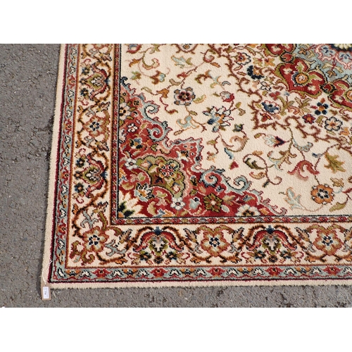 714 - Two modern Persian Rugs on beige ground with multi floral borders, central circular floral motifs, 9... 