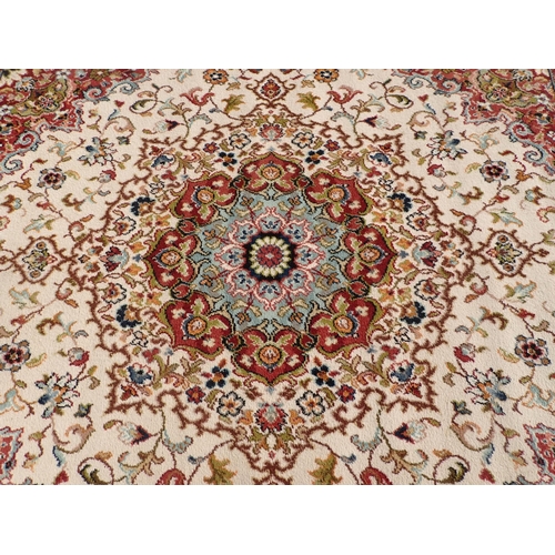 714 - Two modern Persian Rugs on beige ground with multi floral borders, central circular floral motifs, 9... 