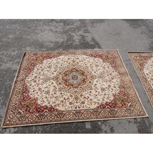 714 - Two modern Persian Rugs on beige ground with multi floral borders, central circular floral motifs, 9... 