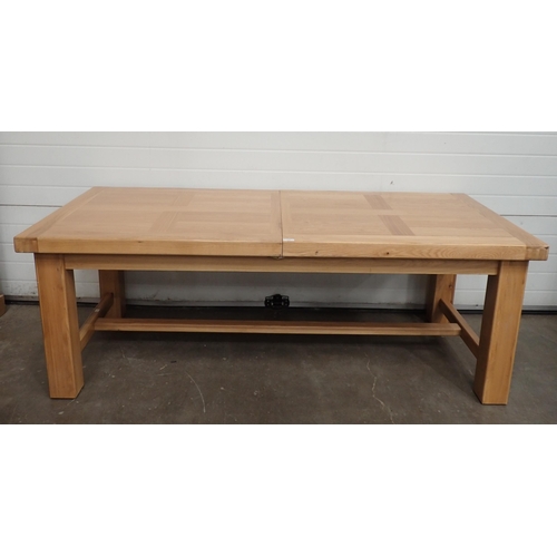 715 - A large modern light oak Dining Table on square supports A/F, 8ft 9