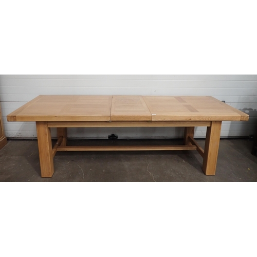 715 - A large modern light oak Dining Table on square supports A/F, 8ft 9