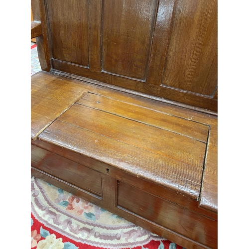 86 - An antique Scumble painted pine panelled back Box seated Settle, 4ft 4