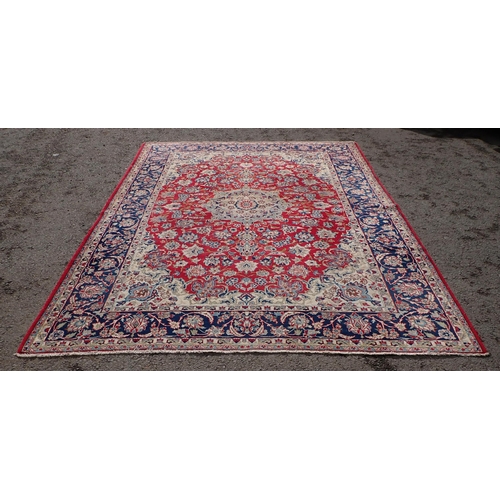 87 - A large Rug on red ground, with multi borders, all over floral designs and large central floral moti... 