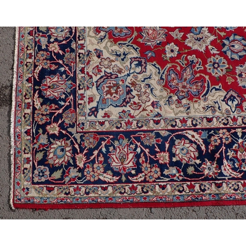87 - A large Rug on red ground, with multi borders, all over floral designs and large central floral moti... 
