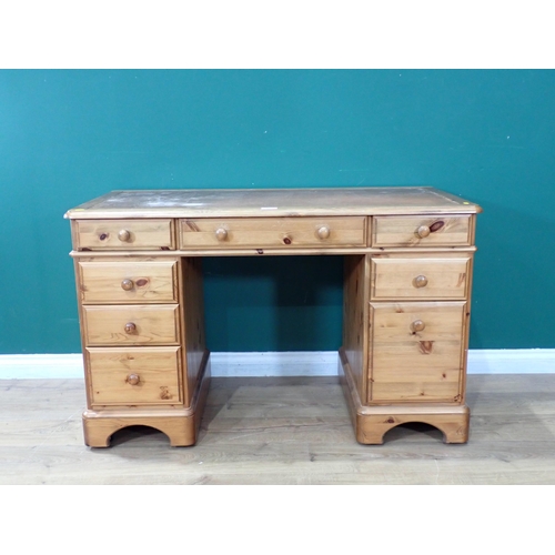 91 - A pine Ducal ltd Desk with rexine bound top with one long drawer and seven short drawers 4ft L 2ft 1... 