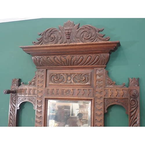 95 - A carved oak mirror back Hall Stand with carved mask and leafage decorations, with single fitted dra... 