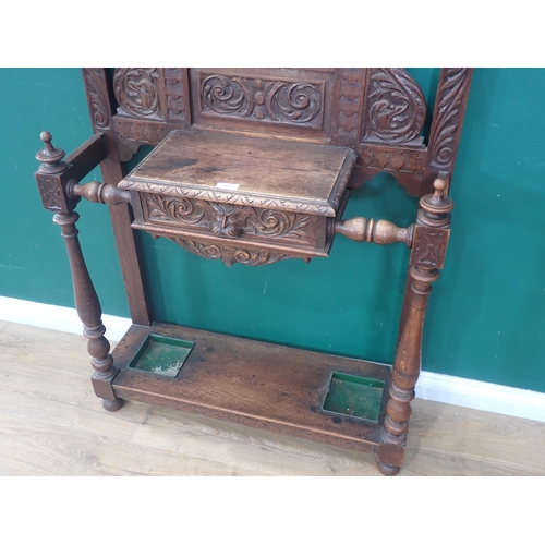 95 - A carved oak mirror back Hall Stand with carved mask and leafage decorations, with single fitted dra... 