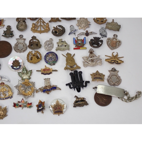 1246 - A quantity of British Army Badges including Royal Marines, Hampshire Yeomanry, Gurkha Transport Regi... 