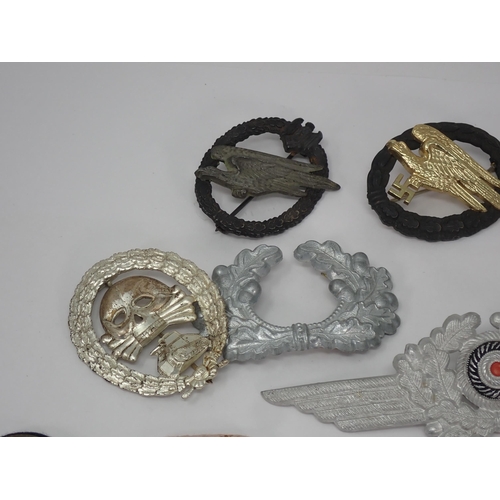 1299 - A collection of German Third Reich metal and cloth Badges