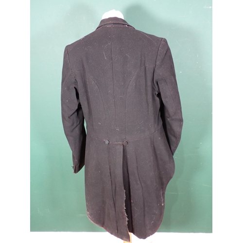 1381 - A black 'swallowtail' Hunting Coat by Huntsman of Saville Row with tattersall lining