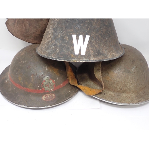 1487 - Two WWII Brodie Helmets, a Warden's Helmet, a Gas Mask in box and a pair of leather Gaiters