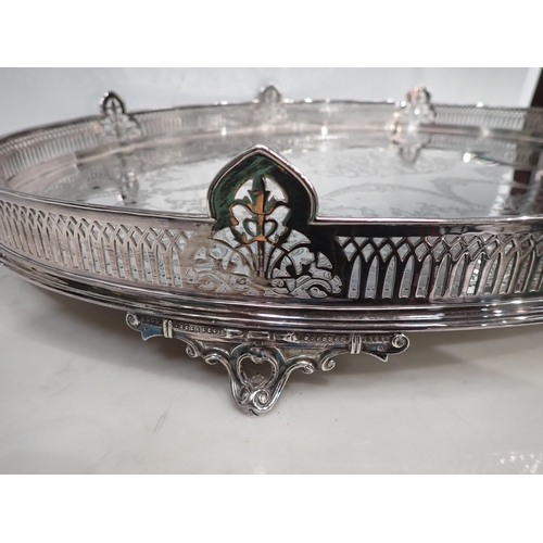 100 - An impressive Victorian silver oval Gallery Tray engraved leafage swags, central initials, raised on... 