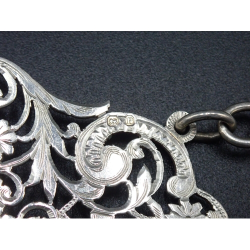 11 - A Victorian silver two part Nurse's Buckle with pierced and engraved floral scroll design, with chai... 