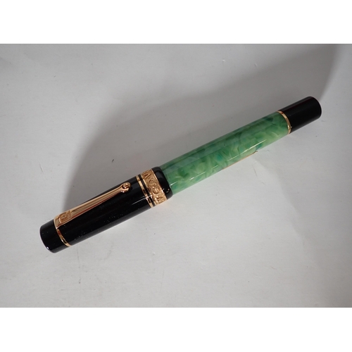 120 - A Delta 'Lugdunum' Fountain Pen, 72/98, green marble case with black cap, 18k nib, in box