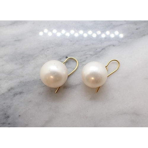 143 - A pair of freshwater Cultured Pearl Earrings on shepherd's hook gold fittings