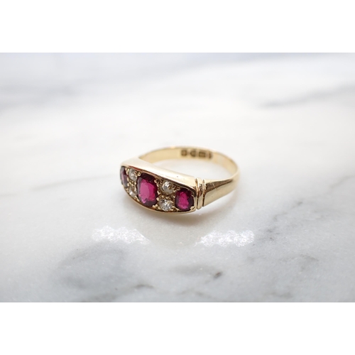 146 - An Edwardian Ruby and Diamond Ring pavé-set three graduated oval-cut rubies with pairs of old-cut di... 