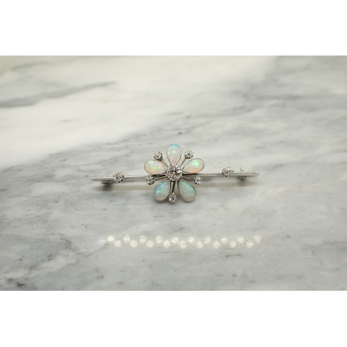 156 - A Diamond and Opal Flower Brooch claw-set old-cut diamond within five pear shaped opal cabochons and... 