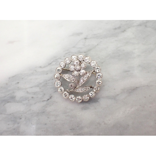 158 - An Art Deco Diamond Flower Pendant/Brooch the openwork plaque with flower in circular frame millegra... 