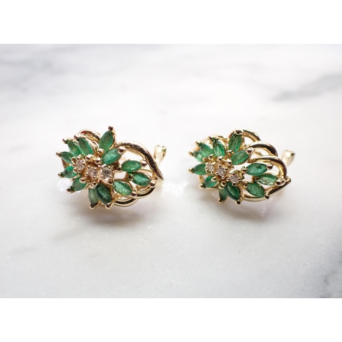 163 - A pair of Diamond and Emerald Cluster Earrings each claw-set three brilliant-cut diamonds within an ... 