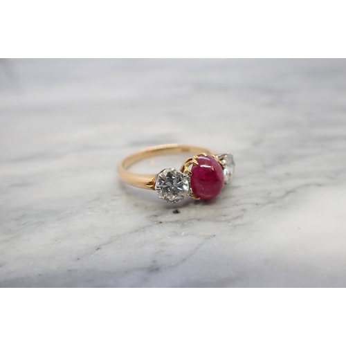 174 - A Ruby and Diamond three stone Ring claw-set oval ruby cabochon between two brilliant-cut diamonds, ... 