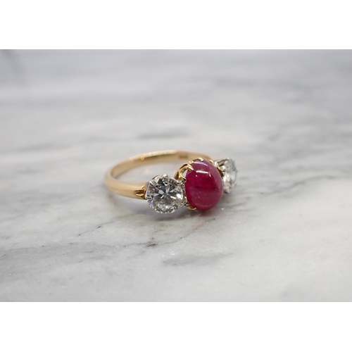 174 - A Ruby and Diamond three stone Ring claw-set oval ruby cabochon between two brilliant-cut diamonds, ... 