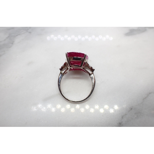 182 - A Ruby and Diamond Ring claw-set oval-cut ruby, 11.43cts, between trios of brilliant-cut diamonds in... 