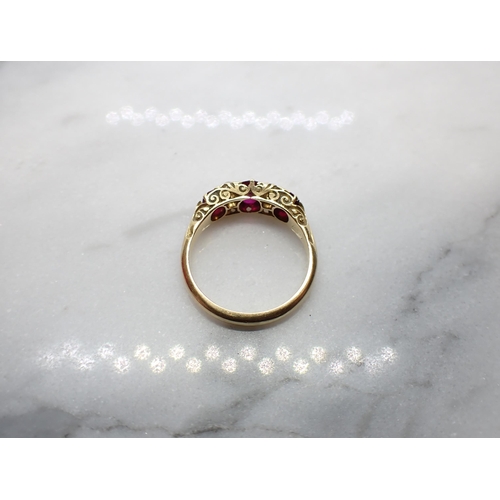 184 - A Ruby and Diamond Ring pavé-set three graduated oval-cut rubies interspersed with pairs of old-cut ... 