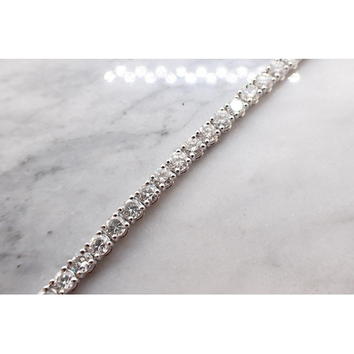 186 - A Diamond Tennis Bracelet having forty six articulated links each claw-set brilliant-cut diamond, to... 