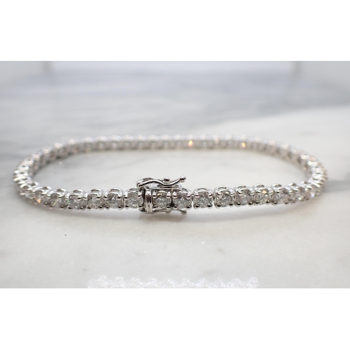 186 - A Diamond Tennis Bracelet having forty six articulated links each claw-set brilliant-cut diamond, to... 