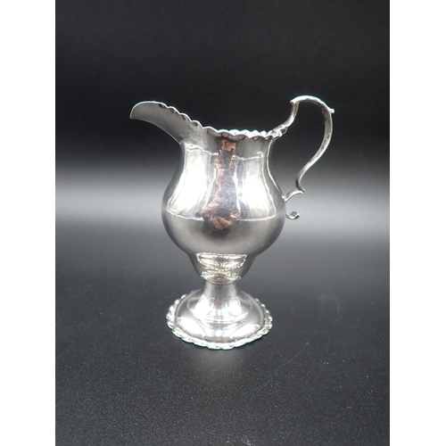 19 - A George III silver baluster Cream Jug with dot punched rim, London 1777