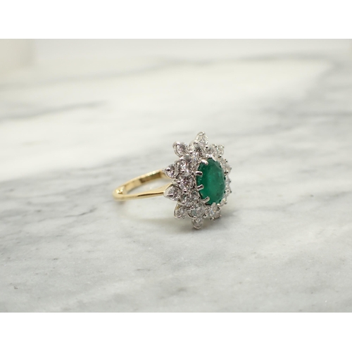 190 - An Emerald and Diamond Cluster Ring claw-set oval-cut emerald within double frame of brilliant-cut d... 