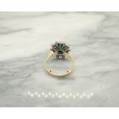 190 - An Emerald and Diamond Cluster Ring claw-set oval-cut emerald within double frame of brilliant-cut d... 