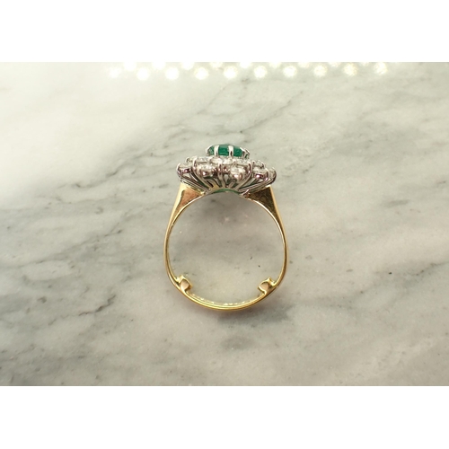 190 - An Emerald and Diamond Cluster Ring claw-set oval-cut emerald within double frame of brilliant-cut d... 