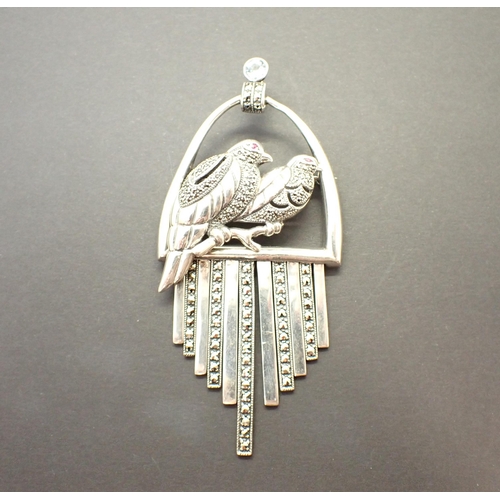 222 - A silver Pendant/Brooch formed as two birds on a perch set marcasite, 9cms top to bottom