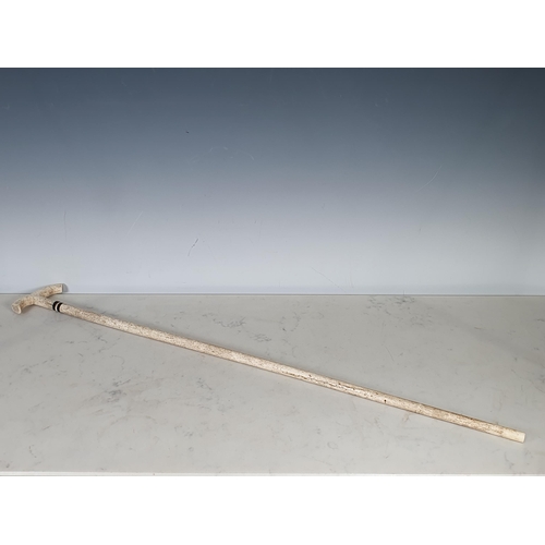 235 - A 19th Century Whalebone Walking Cane with shaped handle with two bands of decoration, 2ft 8